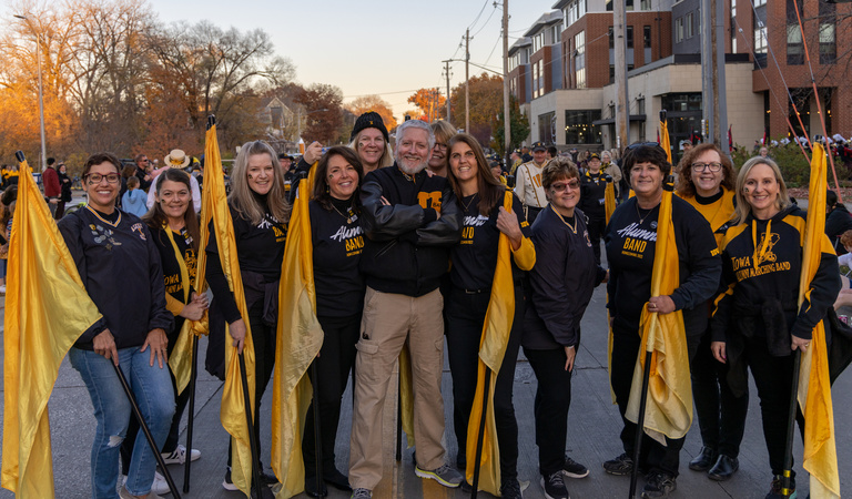 Alumni Band members in downtown Iowa City for the 2022 Homecoming Parade