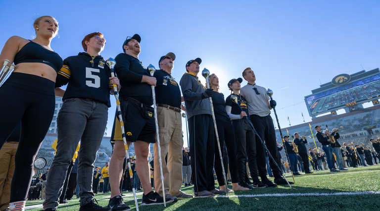Current and former drum majors and golden girls in rehearsal at Kinnick Stadium during Homecoming 2022