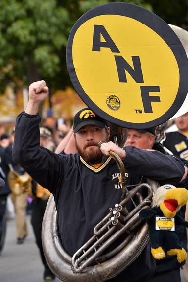 Joe Judge marching with a sousaphone with an "ANF" bell cover