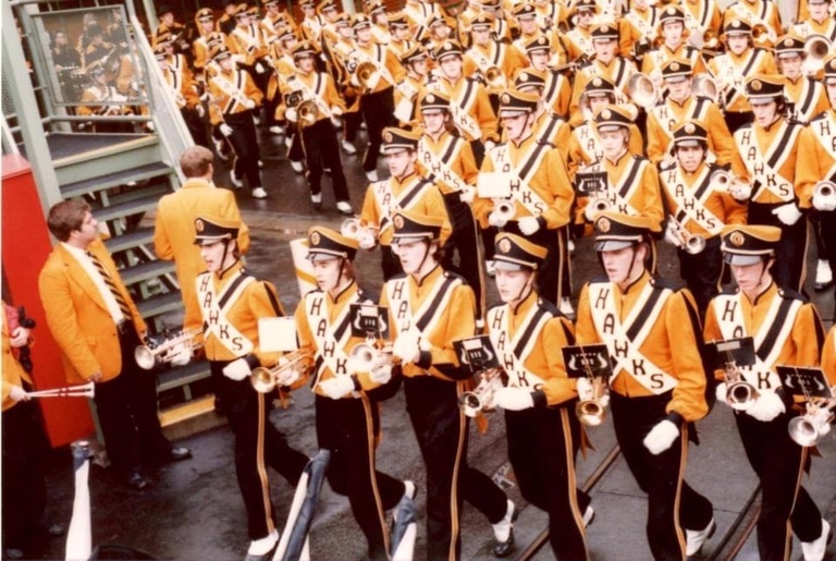 Cathy Shires marching with the Hawkeye Marching Band in a parade