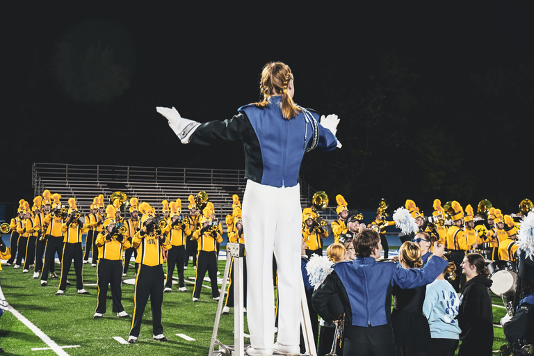 High school drum major conducting the HMB at Quincy High School