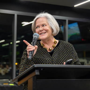Alumni Board President Arlene Houk at the podium during the 2023 HMB Awards Banquet