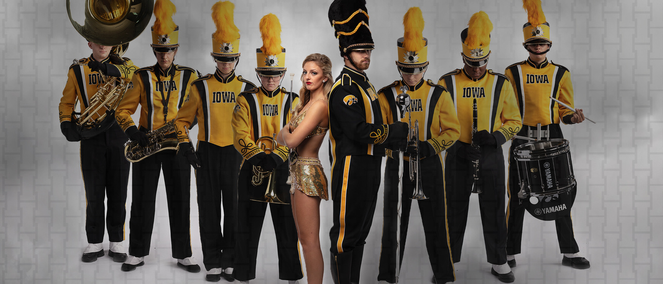 Members of the Hawkeye Marching Band standing in a "flying V" formation
