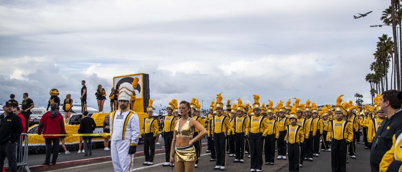 Drum Major Michael Janssen and Golden Girl Kylene Spanbauer lead the HMB in a parade at the Holiday Bowl in San Diego