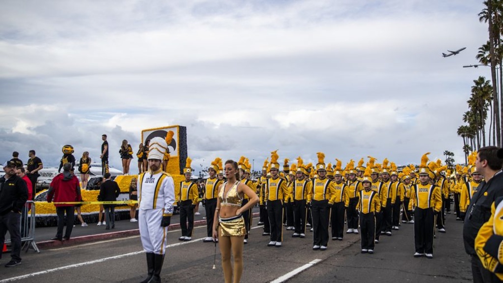 Drum Major Michael Janssen and Golden Girl Kylene Spanbauer lead the HMB in a parade at the Holiday Bowl in San Diego