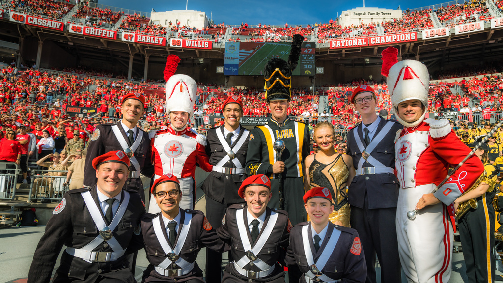 Drum Major Christian Frankl, Golden Girl Ella McDaniel, and Ohio State Marching Band members