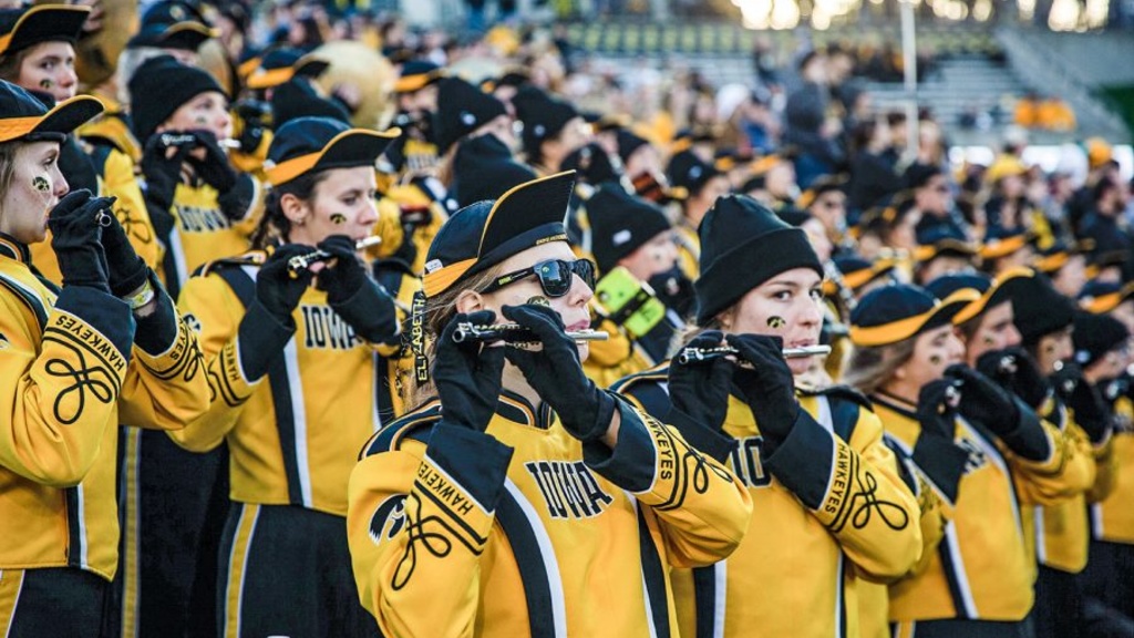 Members of the Hawkeye Marching Band in the stands at Kinnick Stadium